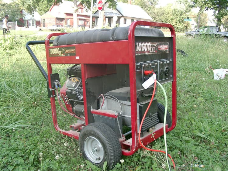 A portable petrol generator on a concrete slab